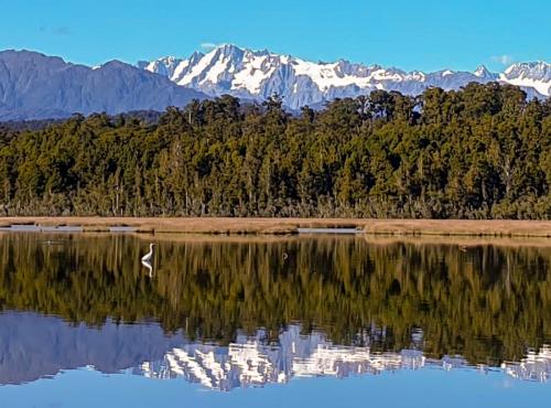 Reflections of the Southern Alps on Okarito Lagoon on the West Coast